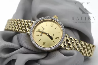 This is a 14K Geneva, Italian, zirconia, 23mm gold watch