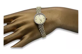 This is a 14K Geneva, Italian, zirconia, 23mm gold watch